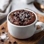 Cottage cheese mug cake in mug topped with chocolate