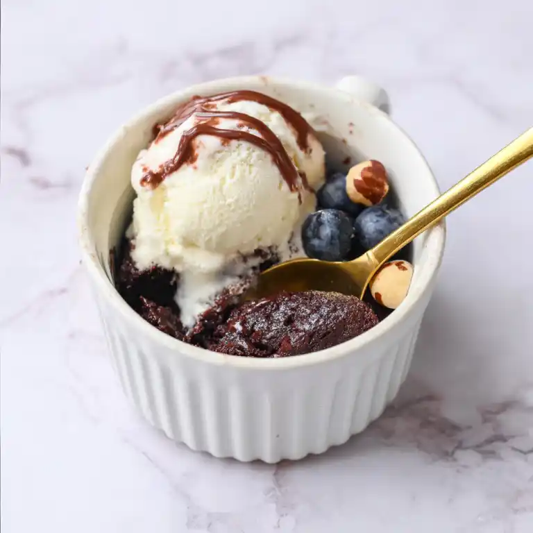 Nutella mug cake served with ice cream and toppings