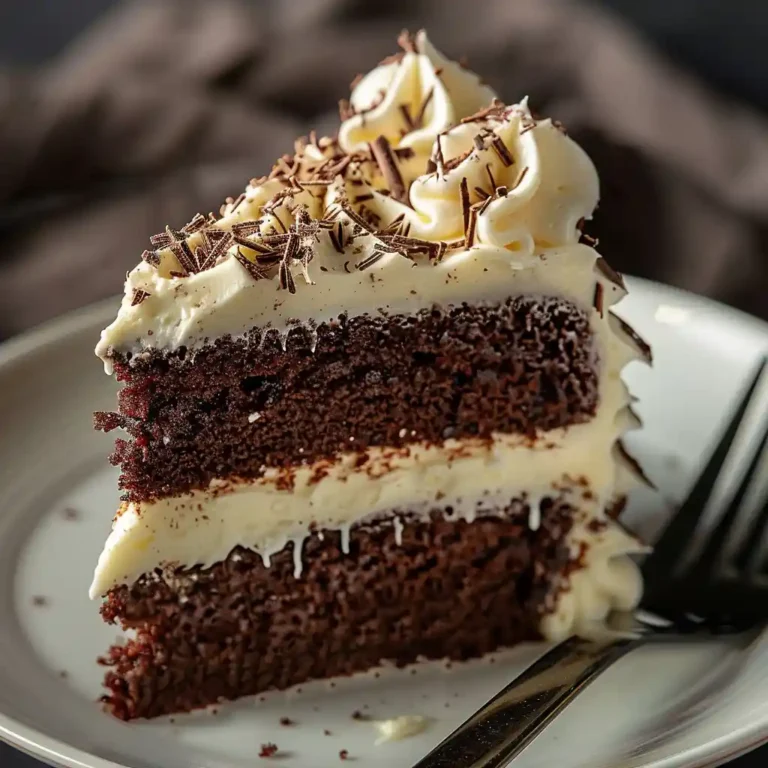 slice of chocolate cake with white chocolate frosting close up