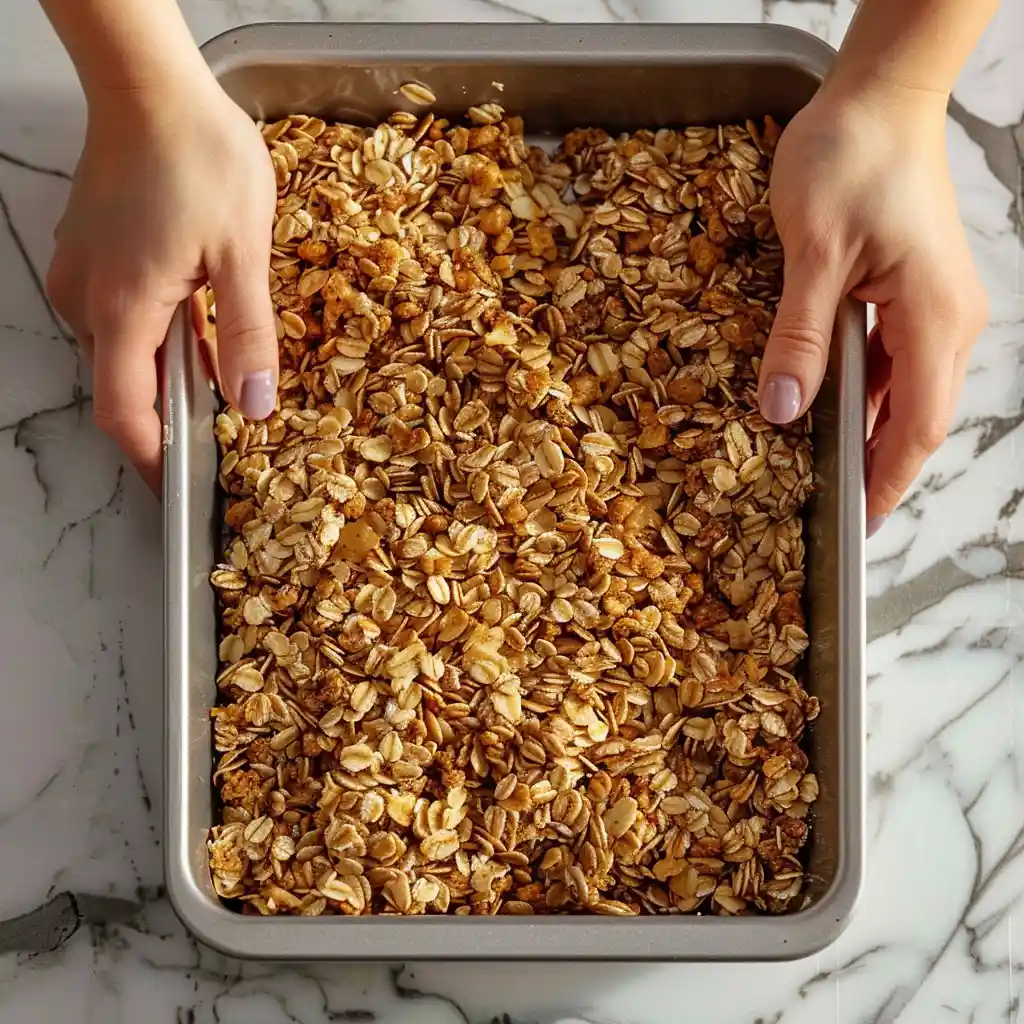 pressing granola bars into pan