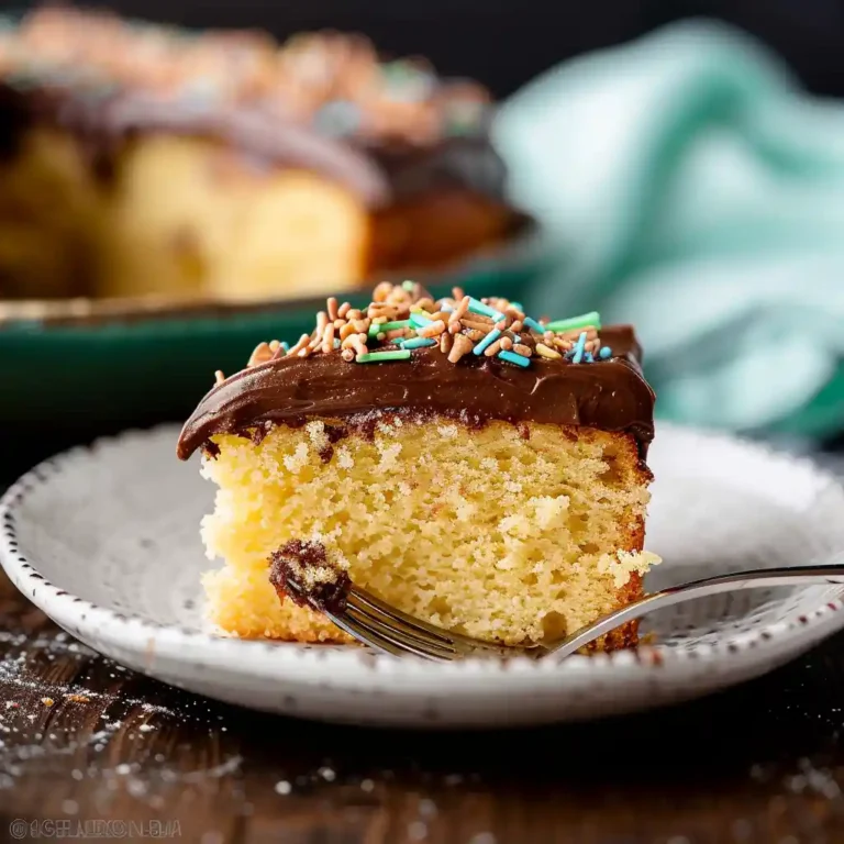 slice yellow sheet cake with chocolate frosting close up