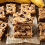 Banana blondies broma bakery stacked on parchment paper